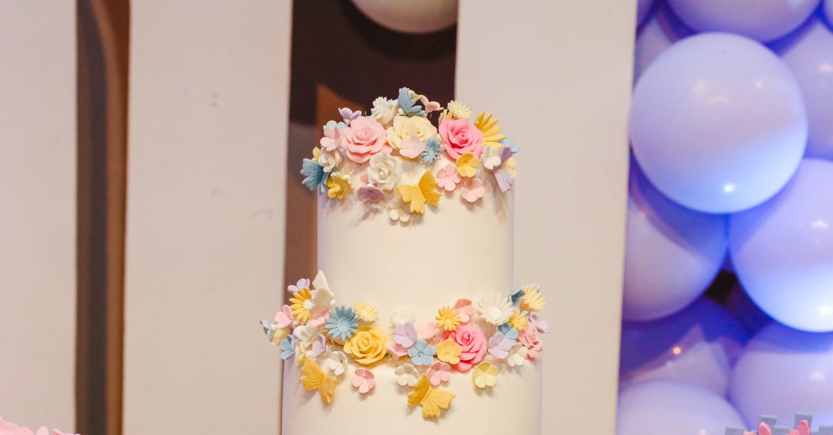 A beautifully decorated cake featuring pastel floral designs, perfect for celebrations and parties.