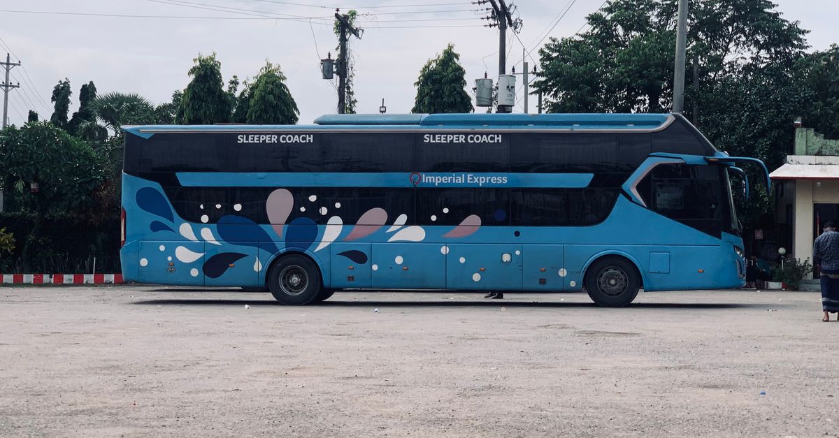 Side view of Imperial Express sleeper coach bus in Dhaka, Bangladesh.