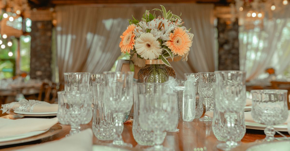 Crystal glassware and floral centerpiece adorn an elegant dining setup, creating a warm and festive ambiance.