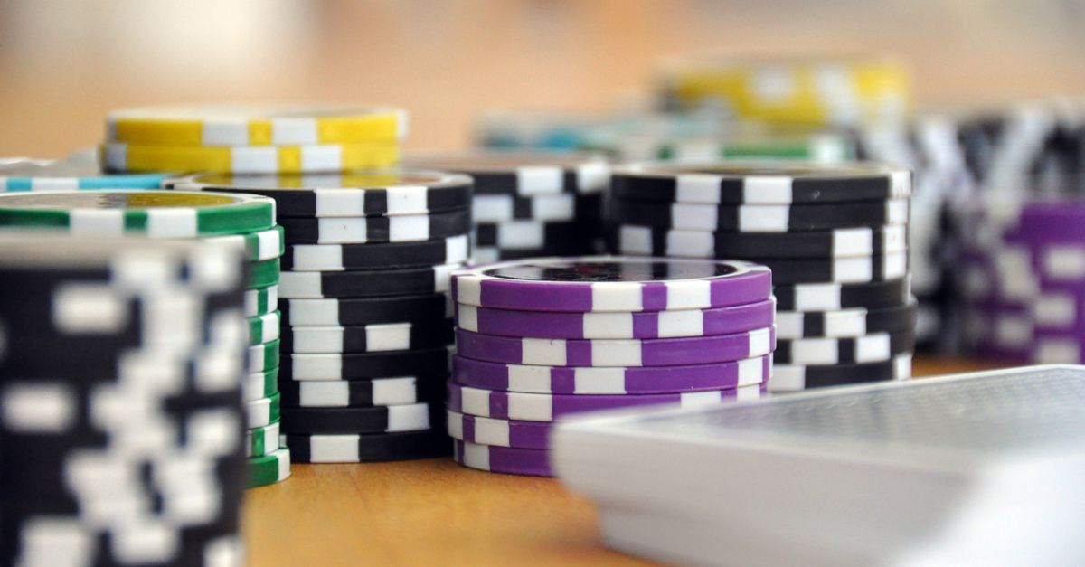 A close-up shot of stacked poker chips and playing cards on a table, perfect for casino and gambling themes.