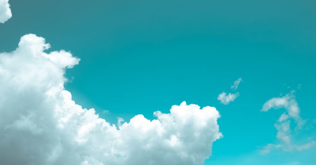 Bright and serene view of fluffy white clouds against a vibrant blue sky.