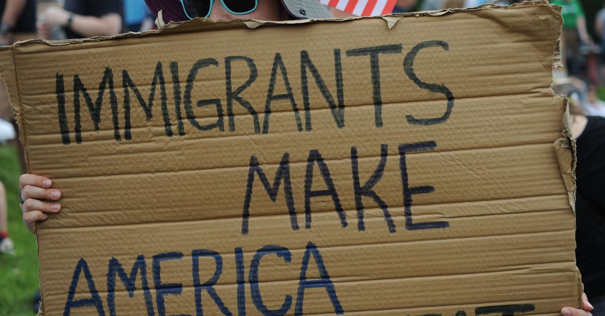 Close-up of sign reading 'Immigrants Make America Great' at a Baltimore rally.