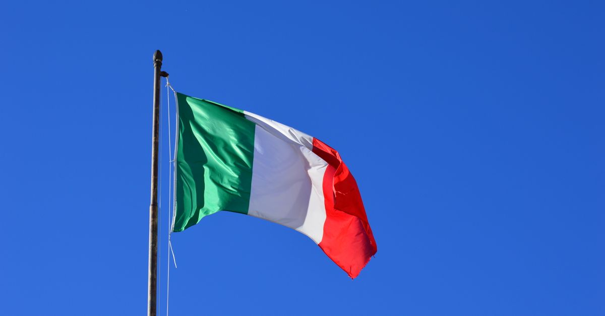 Italian flag flying against a vibrant blue sky, symbolizing national pride and identity.