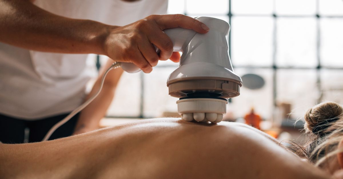 A serene body massage session with an electronic massager promoting relaxation.
