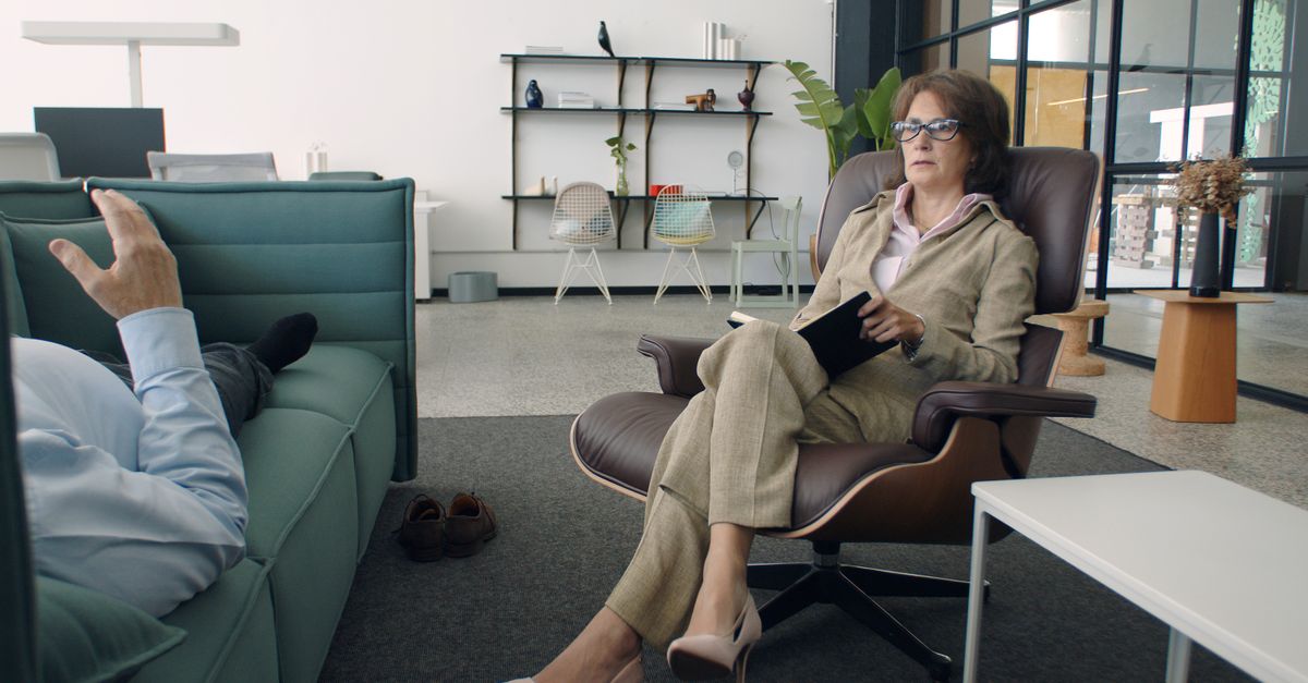 A psychiatrist and patient during a session in a modern office. Calm and professional atmosphere.