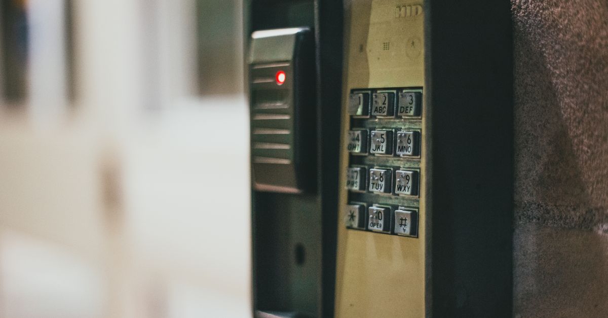 Close-up of a security access control keypad with illuminated buttons for keyless entry.