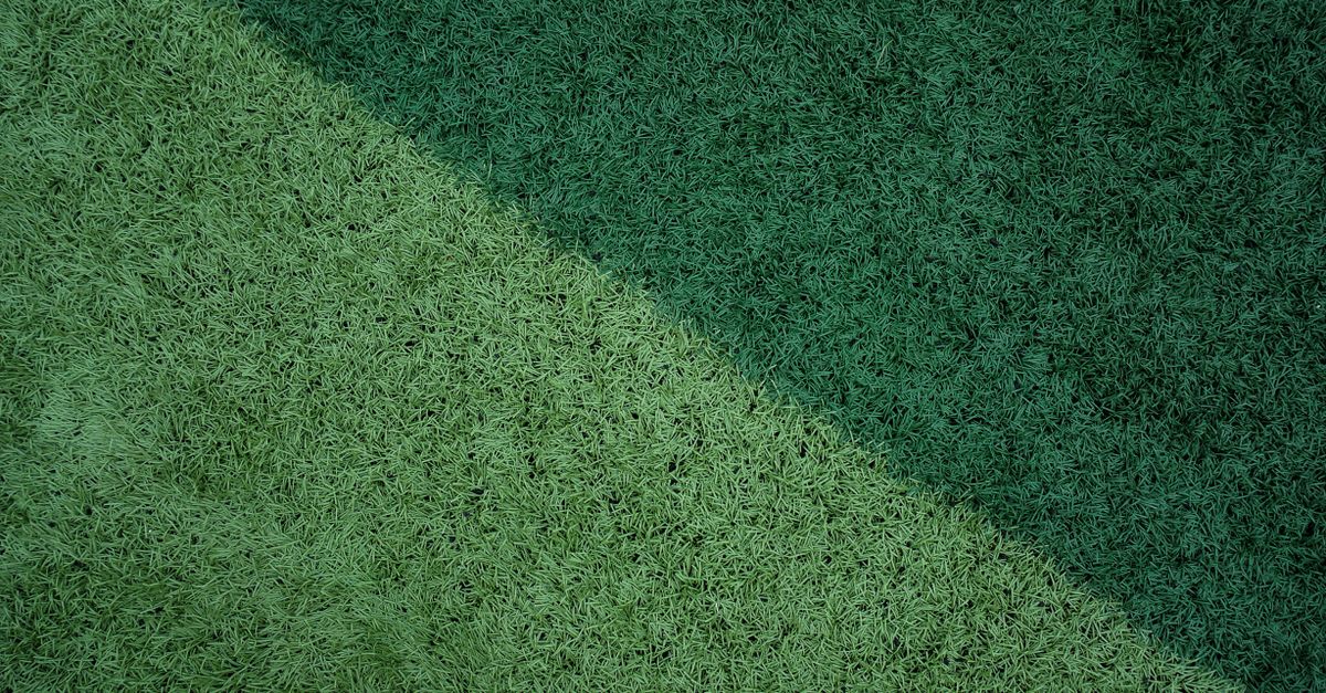 Close-up of a vibrant green grass surface with contrasting tones for design backgrounds.
